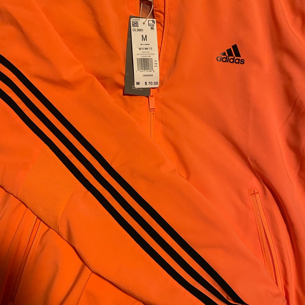 Bright orange Adidas windbreaker. Brand New with tags